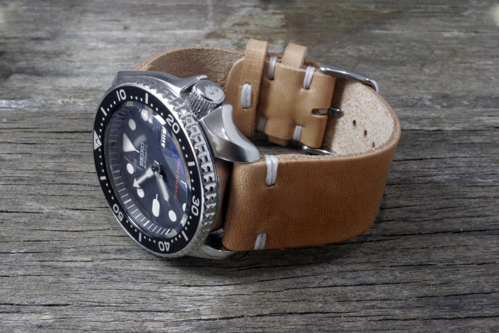 22mm natural veg tan waxed white stitch top with watch on side.jpg